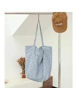 Light blue Japanese style polka dot nylon tote bag hanging on a minimalist metal rack