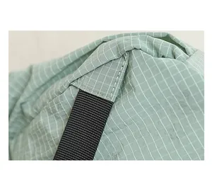 Detailed macro shot of light green grid nylon fabric and sturdy black strap