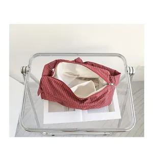 Interior details showing internal pockets of the red checkered nylon messenger bag