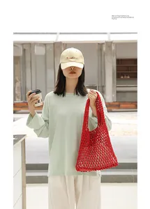 Detailed view of a red cotton woven mesh shoulder bag with a hollow-out design