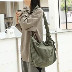 Casual Japanese style green checkered nylon messenger bag for women worn by model