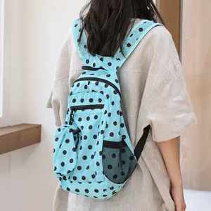 Mochila informal de nailon azul con lunares negros y bolsillo lateral de malla diario