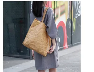 Casual retro Dupont paper tote bag with crinkled texture shown on female shoulder