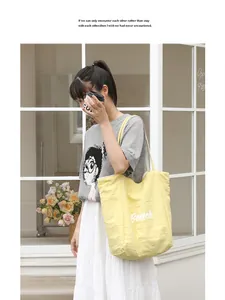 Elegante bolso tote de nailon amarillo con estampado Beach en un entorno urbano.