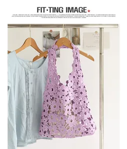 Detailed view of purple floral crochet shoulder bag with intricate lace flower patterns