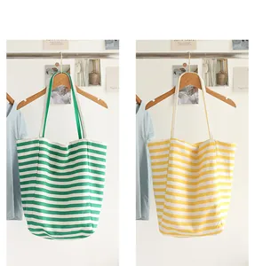Detailed view of Japanese style striped canvas tote bags in green and yellow colors.