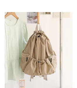 Close-up of a beige checkered nylon drawstring backpack in an aesthetic room setting