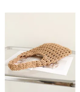 Detailed texture of hand-woven hollow-out shoulder bag with drawstring pouch