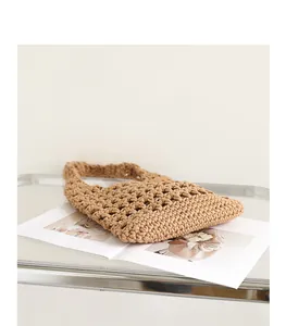 Close-up of handmade woven cotton rope underarm bag with stylish hollow-out design