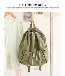 Detail view of olive green checkered nylon backpack with pleated drawstring design