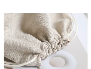 Close-up macro view showing the natural linen fabric texture of a drawstring bag detail