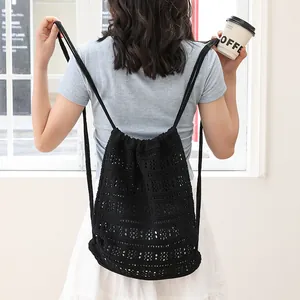 Mochila casual de algodón tejido negro con cordón ajustable y elegante diseño calado