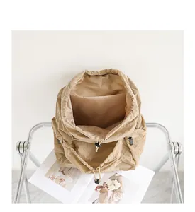 Top view of beige drawstring nylon backpack showing large interior storage compartment