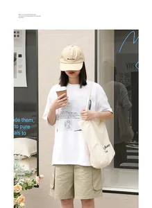 Lifestyle shot of a woman carrying a minimalist cream canvas tote bag with 'fave' print.