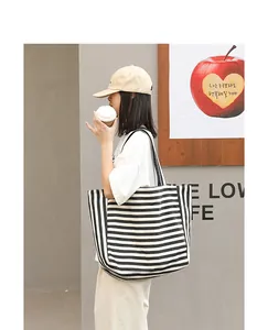 Stylish Japanese style striped canvas tote bag shown being carried in a lifestyle setting.
