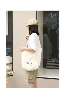Detailed view of the cream nylon tote bag with elegant black letter print for women