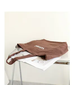 Stylish brown linen tote bag with Salomé letter print on a transparent display table