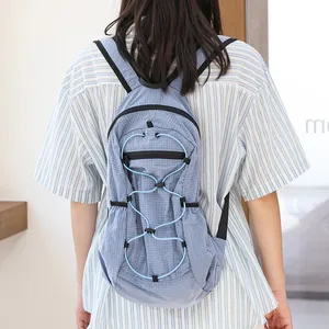 Japanese style light blue grid nylon backpack with drawstring detail for daily use