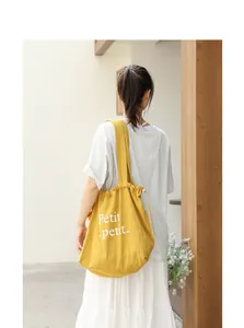 Elegante bolso de algodón amarillo mostaza con cordón e inscripción Petit en blanco