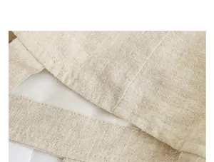 Close-up detail of a minimalist linen tote bag showing fabric texture and lining