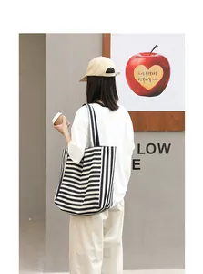 Japanese style casual black and white striped canvas tote bag used in street scene
