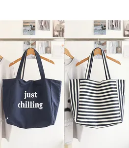 Side-by-side comparison of navy nylon tote with 'just chilling' text and striped canvas bag