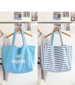 Japanese style striped and solid blue nylon tote bags for women hanging on a rack