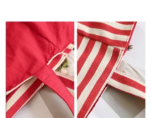Detail view of the red nylon fabric and striped handles of the casual tote bag.