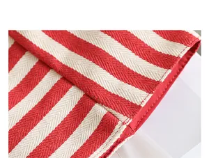 Macro view of the red and white striped herringbone weave on this casual canvas tote bag
