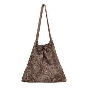 Sac à bandoulière vintage en toile marron avec motif de broderie paisley blanc élégant