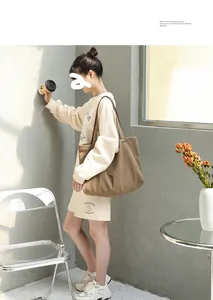 Japanese style brown canvas tote bag carried by a model in casual street setting