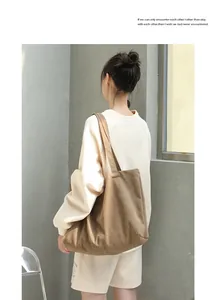 Detailed back view of a minimalist brown canvas shoulder bag styled with daily outfit