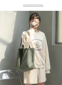 Large olive green canvas tote bag for women shown in a stylish casual lifestyle setting