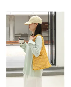 Close-up detail of a yellow cotton thread woven mesh shoulder bag for casual styling