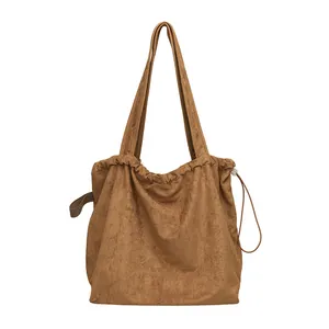 Minimalist brown suede tote bag featuring a drawstring closure and Japanese casual style