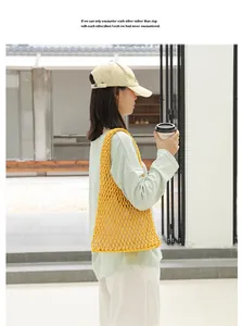 Vibrant yellow hand-woven cotton mesh shoulder bag with a drawstring inner pouch
