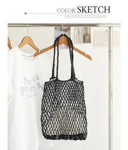 Casual black cotton woven mesh tote bag with drawstring inner pouch on a rack