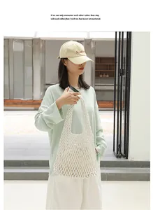 Detailed view of the white hand-woven mesh shoulder bag styled with casual outfit.