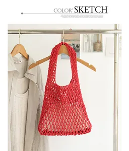 Red crochet woven net shoulder bag with inner pouch on a wooden hanger