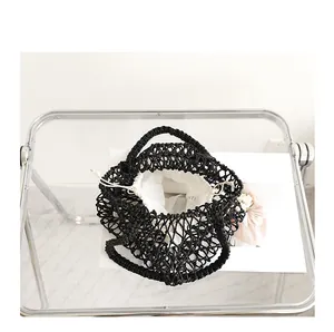 Top view showing the white drawstring pouch inside the black woven mesh beach bag