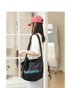Casual black nylon crossbody bag with blue OOOOVS letters and knotted strap detail