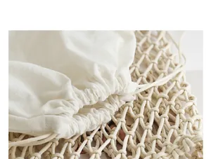 Close-up detail of a cream woven mesh bag with a cotton drawstring inner pouch