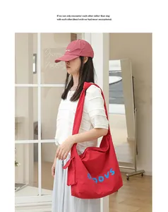 Casual red crossbody bag featuring blue letter print and trendy knot strap detail for women