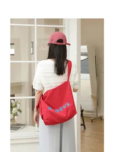 Casual red nylon crossbody bag with letter print and knot detail worn by a model