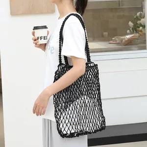 Fashionable black cotton woven mesh beach bag with white drawstring inner pouch