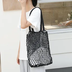Stylish black woven mesh shoulder bag for casual beach trips and daily summer outings