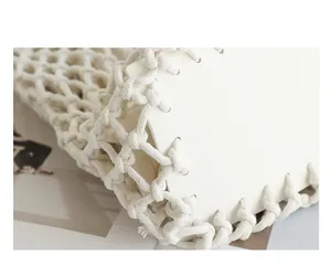 Close-up detail showing the intricate white cotton rope weaving of a minimalist fashion bag
