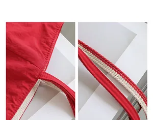Vista detallada del bolso tote de nailon rojo con costuras reforzadas y asas tejidas