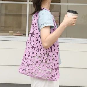 Purple floral lace shoulder bag with hollow-out design and drawstring inner pouch