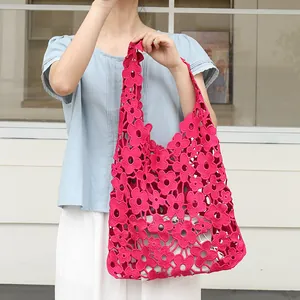 Vibrant pink floral crochet shoulder bag with hollow lace design and inner pouch.